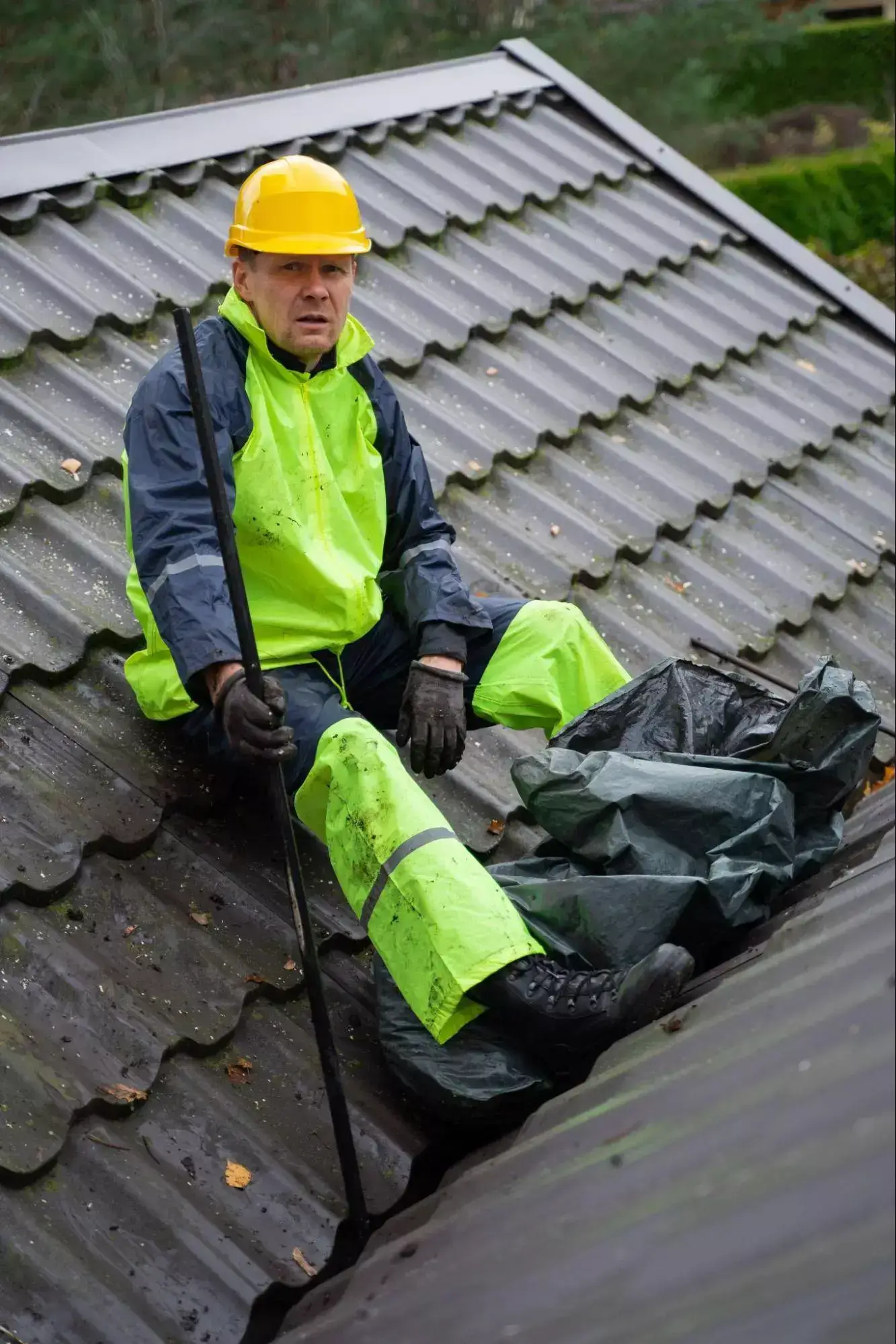 House Cleaning Worker Sitting on the Roof Image
